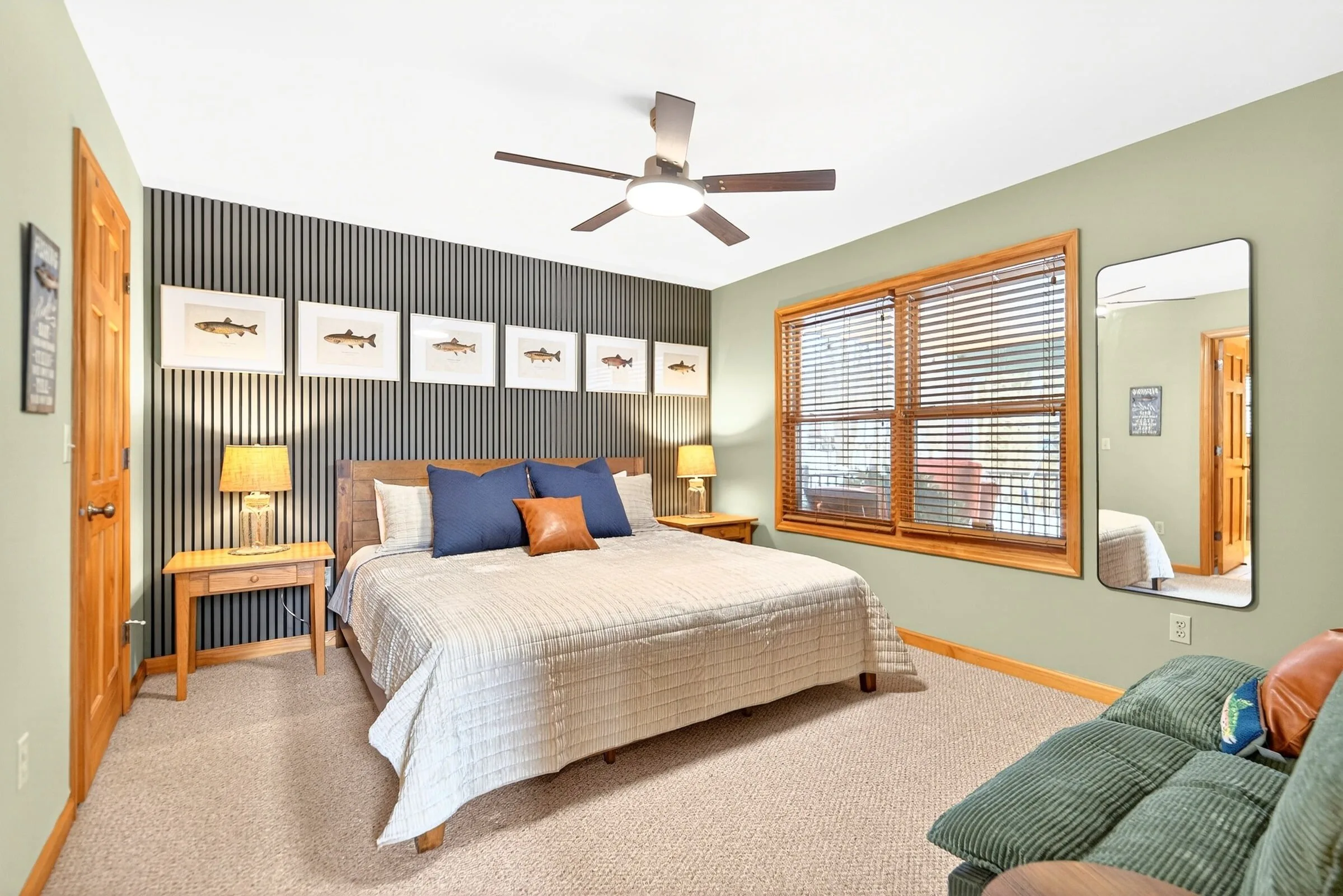 Bedroom with a king bed, striped accent wall and a daybed