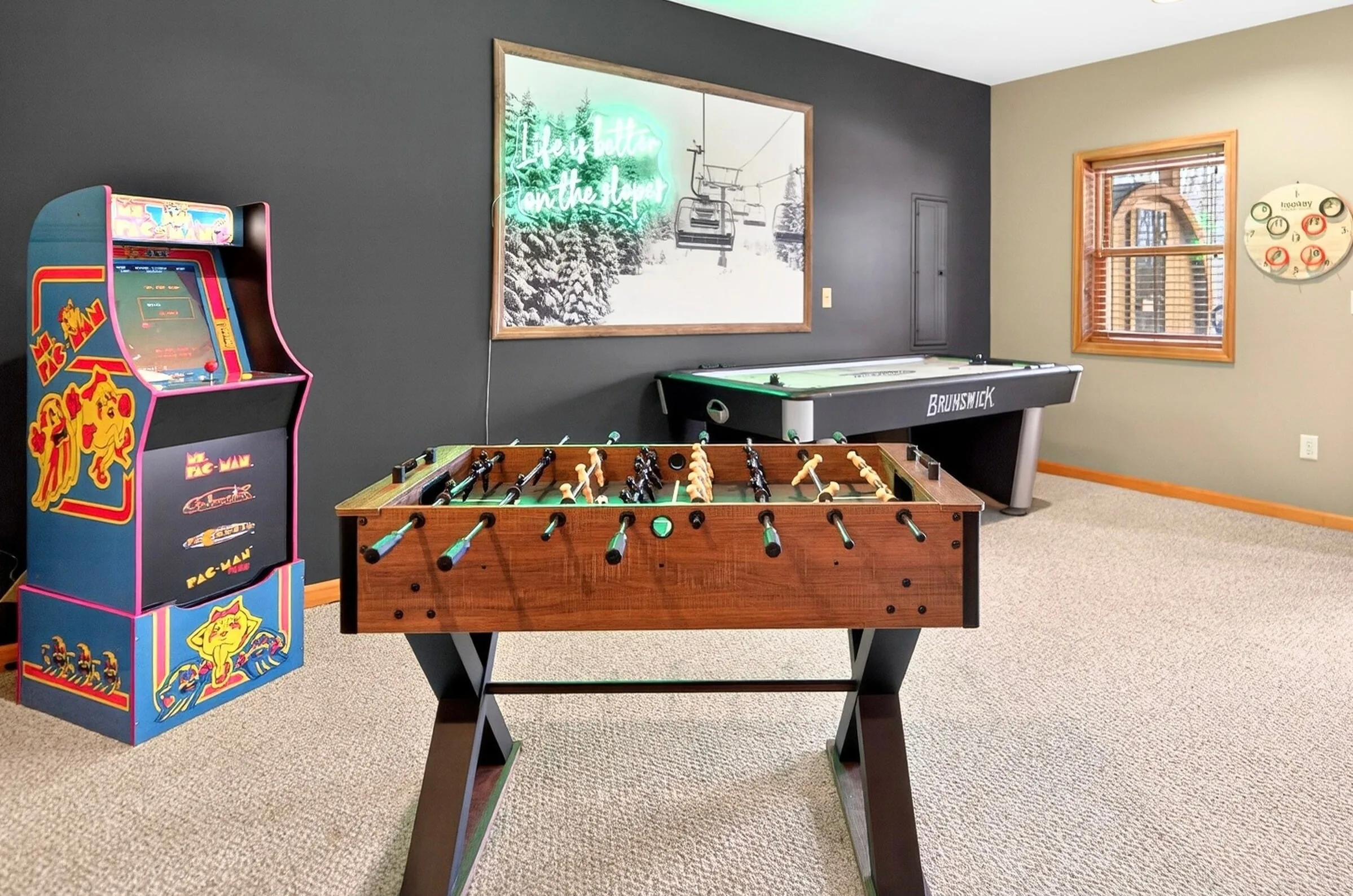 Game room with arcade cabinet, foosball table and air hockey