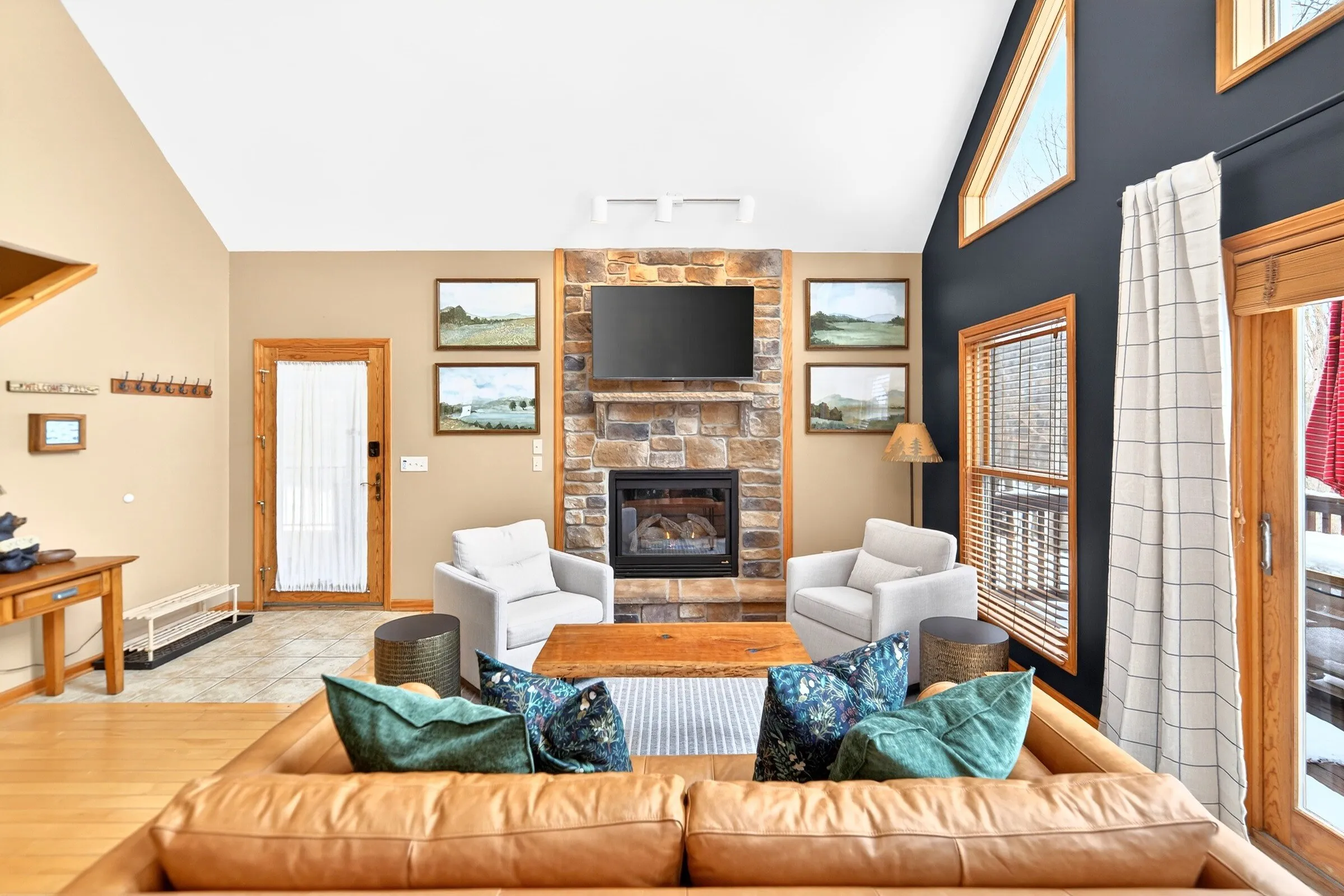 Great room with stone gas fireplace and leather sectional