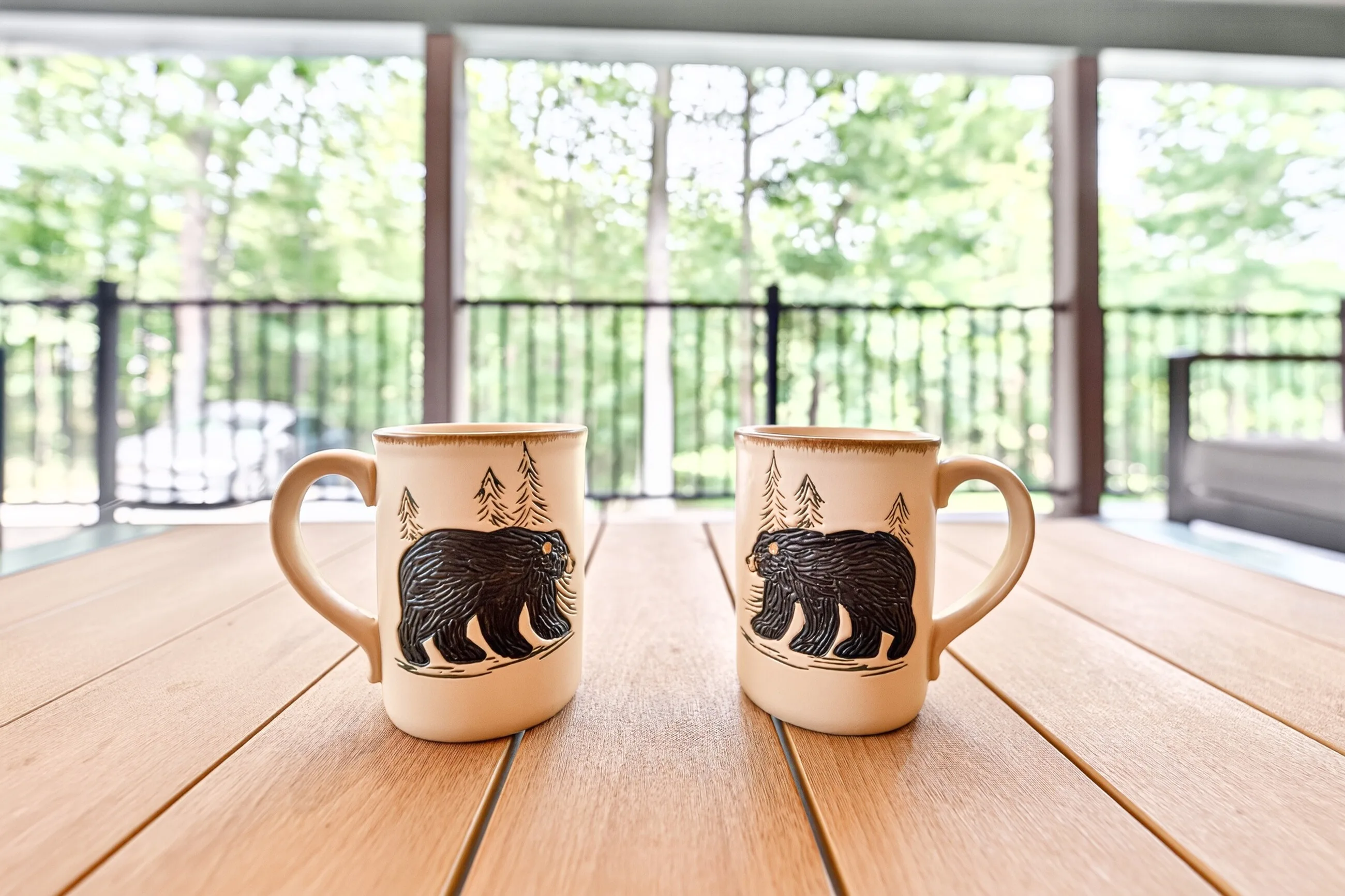 Two bear mugs on the deck table in the morning